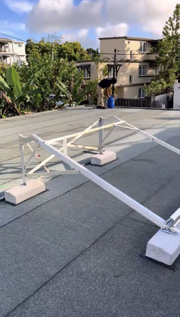 Même toiture recouverte d'une membrane neuve, supports de panneaux solaires posés sur des slabs